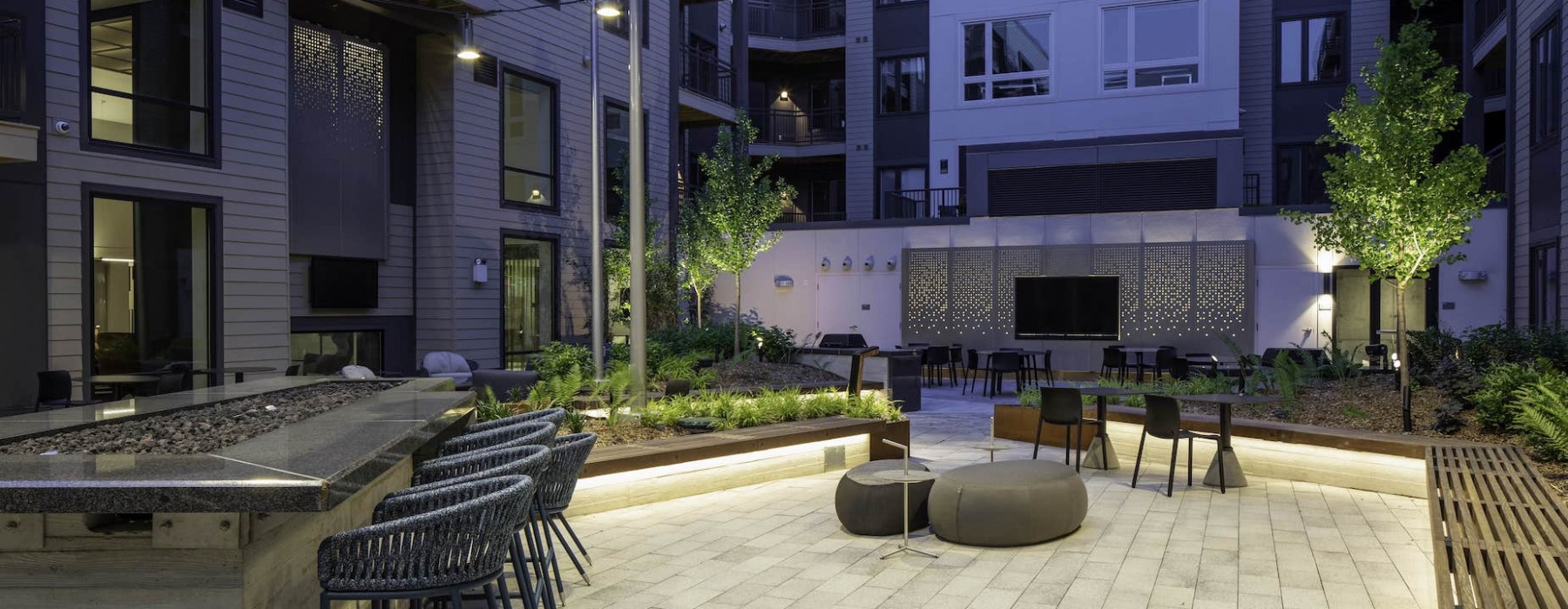 the andi apartments Dorchester courtyard with tv, fireplace, and ample seating
