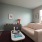 the andi apartments dorchester studio apartment with couch seating, floor to ceiling windows, and hardwood style flooring.